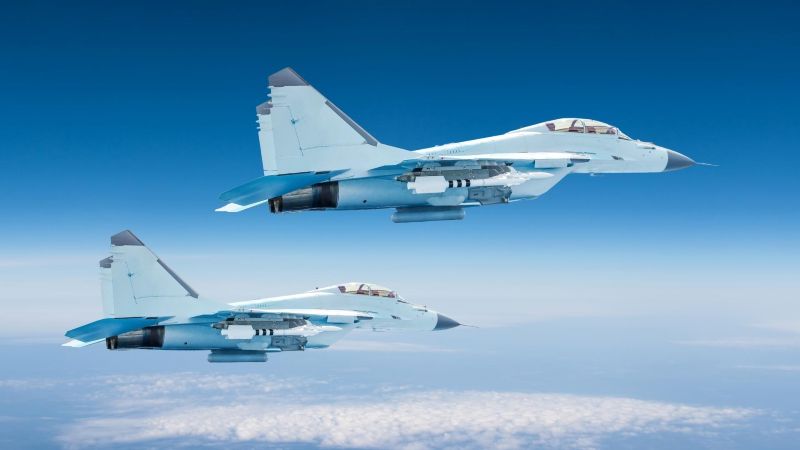 Two fighter jets flying in formation