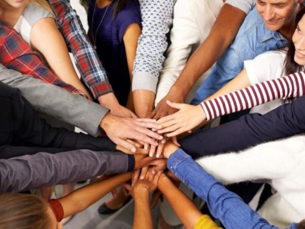 Team circle stacking hands