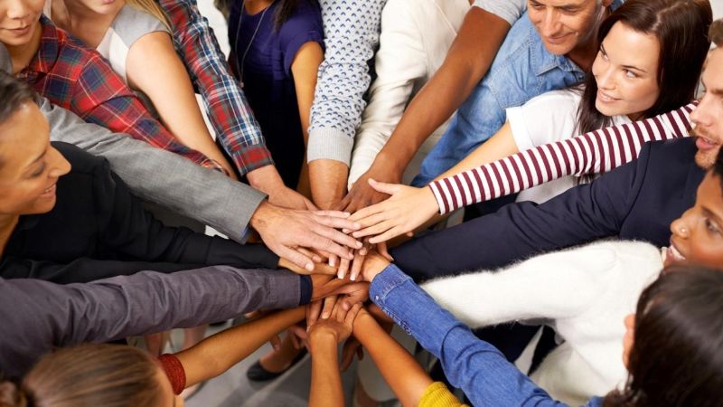 Team circle stacking hands