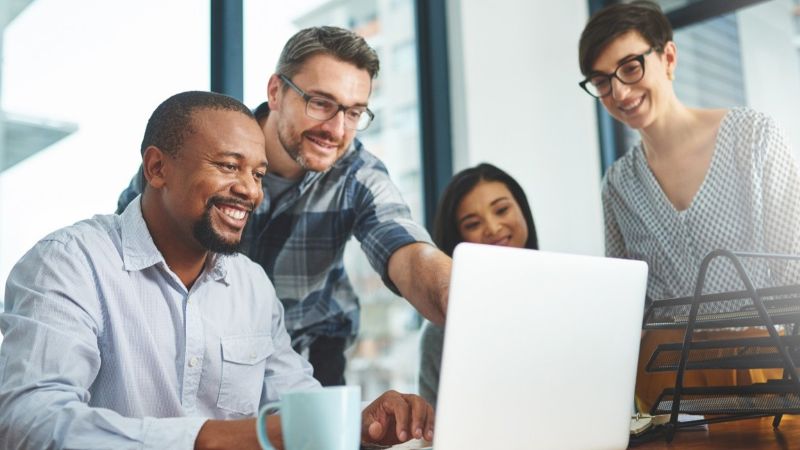 Team working together around a laptop